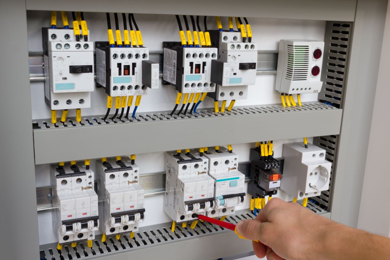 Technician Working At Electrical Cabinet — Mid Coast Switchboards in Macquarie NSW